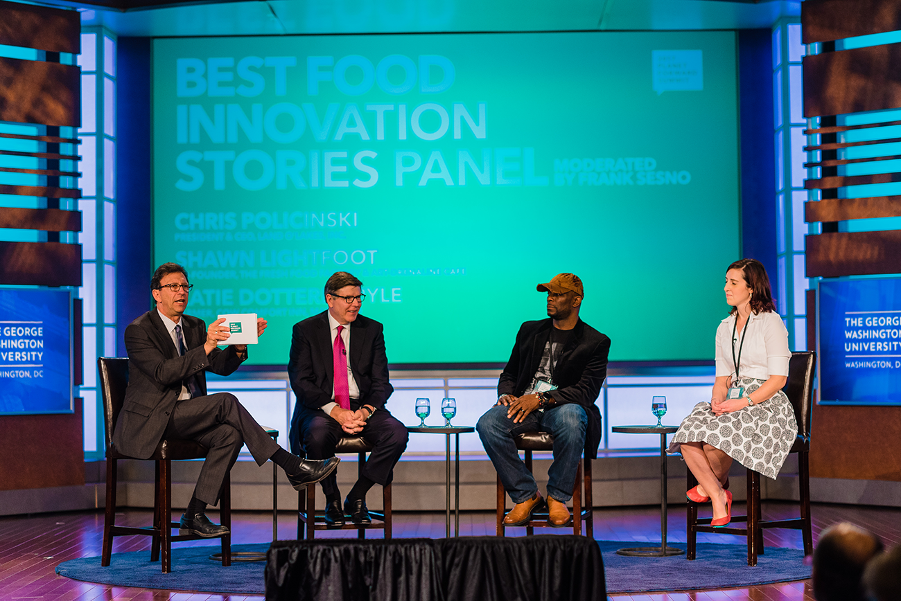 Frank Sesno (left) engages Land O&#039;Lakes CEO Chris Policinski (left-center), Fresh Food Factory Co-Founder Shawn Lightfoot (right-center), and Cow Comfort Inn Owner Katie Dotterer-Pyle (right) in a conversation about innovation.